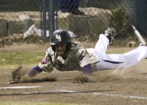 Robbie Senior slides at home with a go-ahead run Thursday against Mt. Whitney. Lemoore won the game 7-6.